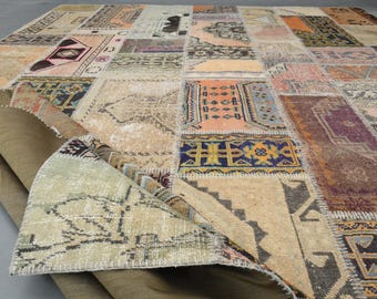 May include: A patchwork rug with a variety of colors and patterns, including beige, brown, red, and blue. The rug is made of different pieces of fabric sewn together, creating a unique and eclectic design.
