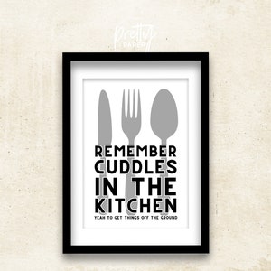 May include: Black and white kitchen-themed print with a knife, fork, and spoon in gray. The text reads "Remember cuddles in the kitchen. Yeah to get things off the ground."