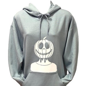 An all white Jack-O-Lantern head design where someone head is cut off and replaced with a smiling pumpkin.