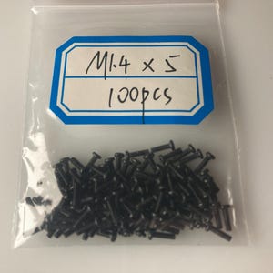 May include: A clear plastic bag containing a large quantity of small black screws. A white label with blue trim reads "M1.4 x 5 100pcs".