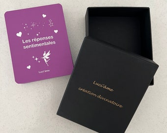 May include: A purple box with the text "Les réponses sentimentales" and a fairy illustration. The box is open and the inside is black with the text "Luci'âme création divinatoire".
