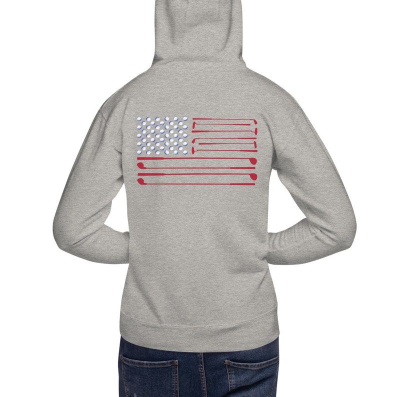May include: A gray hooded sweatshirt with a golf-themed American flag design on the back. The flag is made up of golf balls and golf clubs.