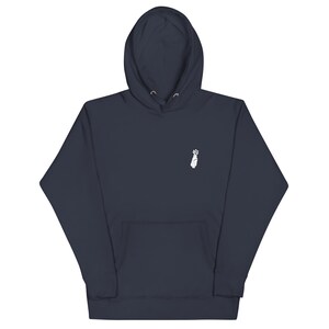 May include: A navy blue hooded sweatshirt with a white graphic of a hand holding a golf club.
