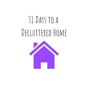 May include: White background with the text "31 DAYS TO A DECLUTTERED HOME" in black. Below the text is a purple house icon. The image is a simple graphic design.