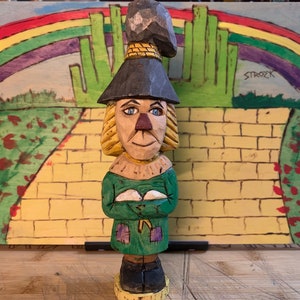 A Hand carved Folk Art style Scarecrow from the 1939 film, &quot;The Wizard of Oz&quot;.