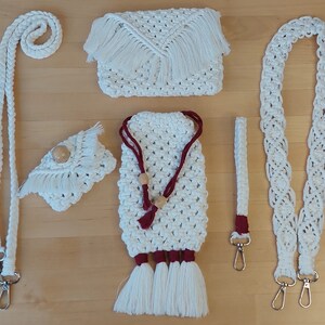 May include: Set of four white crocheted bags with red and wooden accents. The bags have fringe and are attached to silver clasps.