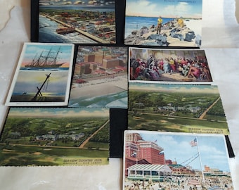 May include: A collection of vintage postcards featuring various scenes of Atlantic City, New Jersey. The postcards depict a ship, a beach scene, a golf course, and a hotel.