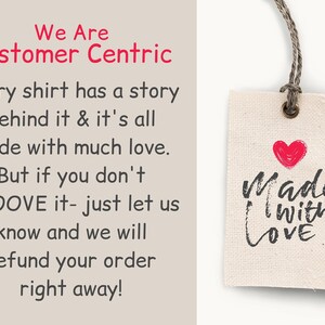 May include: A white fabric tag with a red heart and black text that reads "Made with Love". The tag is attached to a brown string.