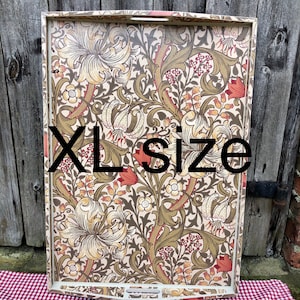 May include: A large white serving tray with a floral pattern in shades of brown, green, red, and cream. The tray has a slightly curved edge and a handle on the top. The text "XL size" is printed on the tray.