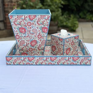 May include: A blue and white tray with a floral pattern and a blue and white wastebasket and tissue box with a floral pattern.