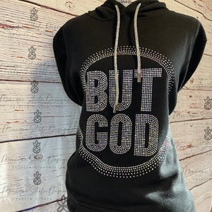 May include: Black hooded sweatshirt with a large rhinestone design that reads "BUT GOD".