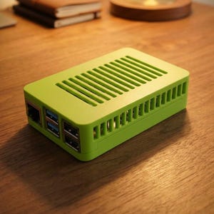 May include: A lime green rectangular computer case with a vented top and side panels. The front face features multiple ports, including an Ethernet port and several USB ports, housed within a solid plastic enclosure designed for a single-board computer.