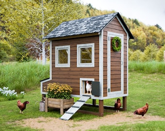 May include: A wooden chicken coop with a brown and white exterior, a ramp, and a wreath on the door. There are several chickens in the yard, including a white chicken inside the coop.