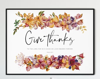 Könnte beinhalten: Ein Aquarelldruck mit einem floralen Rand und dem Text "Give thanks to the Lord for he is good; his love endures forever. Psalm 107:1".