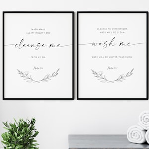 May include: Two black framed prints with white backgrounds and black calligraphy. The left print reads "Wash away all my iniquity and cleanse me from my sin. Psalm 51:2". The right print reads "Cleanse me with hyssop. And I will be clean. Wash me and I will be whiter than snow. Psalm 51:7".