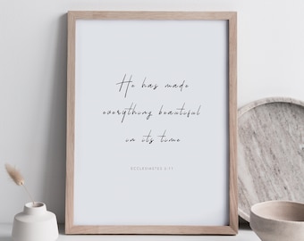 May include: A framed print with a white background and black text that reads "He has made everything beautiful in its time" with the scripture reference "Ecclesiastes 3:11" below the text.