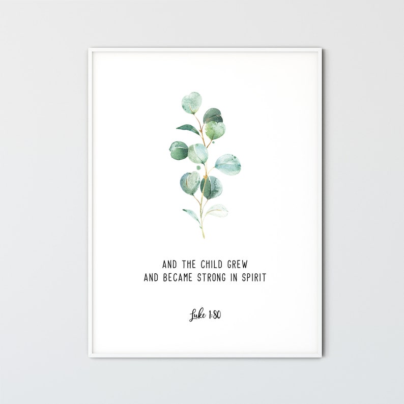 May include: A white framed print with a watercolor illustration of a green eucalyptus branch. The print features the text "And the child grew and became strong in spirit Luke 1:80".