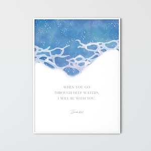 May include: A framed art print featuring a watercolor design of ocean waves in shades of blue and white. The print includes the text "WHEN YOU GO THROUGH DEEP WATERS, I WILL BE WITH YOU." and "Isaiah 43:2".