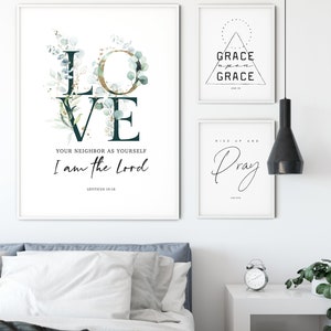 Op de afbeelding: Drie ingelijste prints met inspirerende citaten en bijbelteksten. De eerste print toont het woord "LOVE" met groen en gouden accenten, en het citaat "Heb uw naaste lief als uzelf, Ik ben de Heer, Leviticus 19:18". De tweede print toont een driehoek met de woorden "GRACE upon GRACE" en de bijbelverwijzing "Johannes 1:16". De derde print toont de woorden "Rise up and Pray" met een decoratieve zwier.
