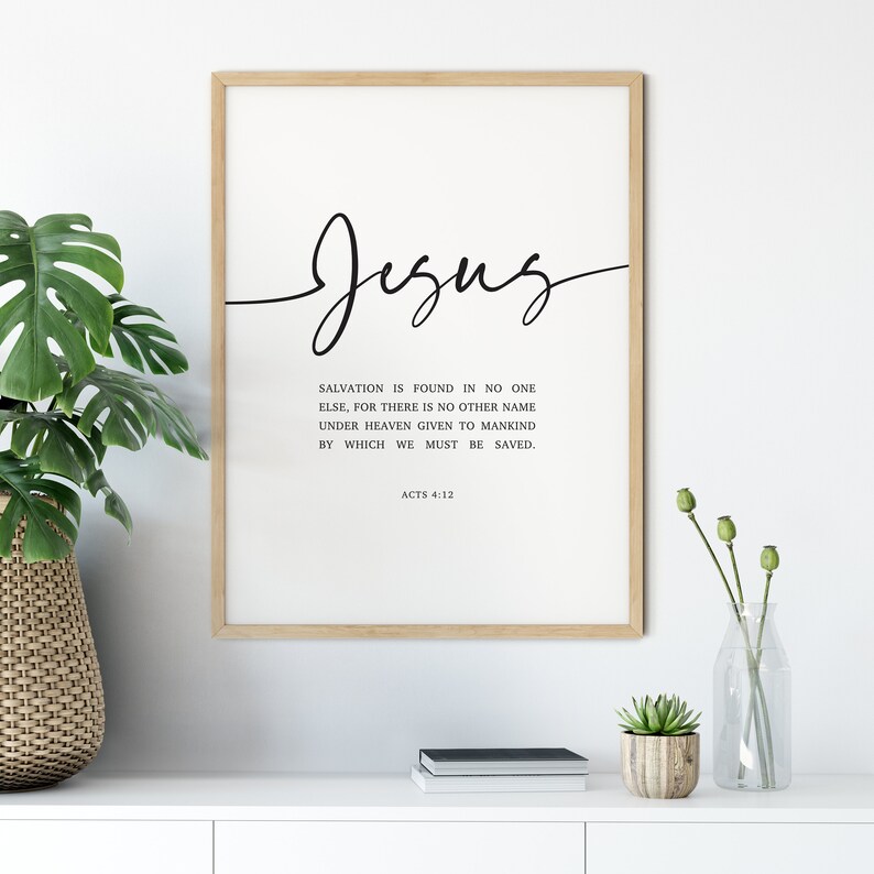 May include: A framed print with a black and white design. The print features the word "Jesus" in cursive script and a Bible verse from Acts 4:12. The verse reads: "Salvation is found in no one else, for there is no other name under heaven given to mankind by which we must be saved."