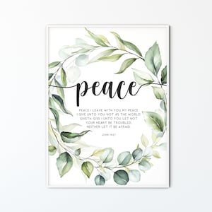 May include: A watercolour print featuring a wreath of green leaves and the word "peace" in a large font. The print includes the Bible verse John 14:27, "Peace I leave with you, my peace I give unto you: not as the world giveth, give I unto you. Let not your heart be troubled, neither let it be afraid."