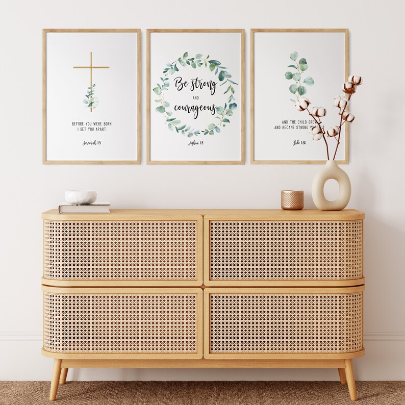 May include: Three framed prints with inspirational quotes and greenery designs. The prints feature the text "Before you were born I set you apart", "Be strong and courageous", and "And the child grew and became strong".