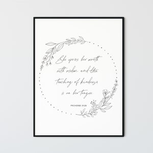 May include: Black and white printable wall art with a floral wreath and the quote "She opens her mouth with wisdom, and the teaching of kindness is on her tongue."  Proverbs 31:26