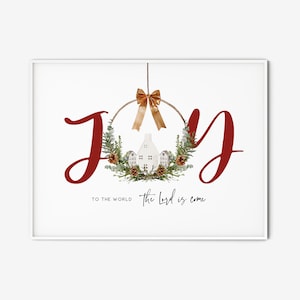 May include: A red "Joy" sign with a Christmas wreath ornament featuring a white house, pine cones, and greenery. The text "To the world the Lord is come" is written below the wreath.