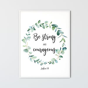 May include: A white framed print with a green watercolor wreath and the text "Be strong and courageous Joshua 1:9".
