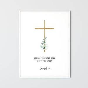 May include: A white printable art print with a gold cross and green leaves. The text reads "Before you were born I set you apart Jeremiah 1:5"