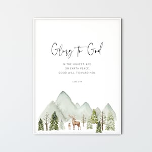 May include: A watercolor print with a mountain scene and two deer. The print features the text "Glory to God" and the Bible verse "Luke 2:14" which reads "In the highest, and on earth peace. Good will toward men."