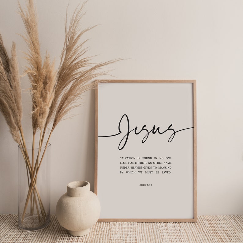 May include: A white framed print with black text that reads "Jesus" in cursive. The text below reads "Salvation is found in no one else, for there is no other name under heaven given to mankind by which we must be saved. Acts 4:12"