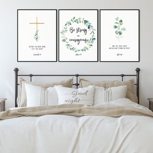 May include: Three framed prints with white backgrounds and black frames. The prints feature watercolor illustrations of eucalyptus leaves and gold lettering with bible verses. The verses are "Before you were born I set you apart" from Jeremiah 1:5, "Be strong and courageous" from Joshua 1:9, and "And the child grew and became strong in spirit" from Luke 2:40.