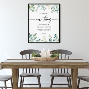 May include: A framed print with a watercolor design of green leaves and branches. The print features a quote from the Bible, Isaiah 43:19, "See, I am doing a new thing. Now it springs up; do you not perceive it? I am making a way in the wilderness and streams in the wasteland."