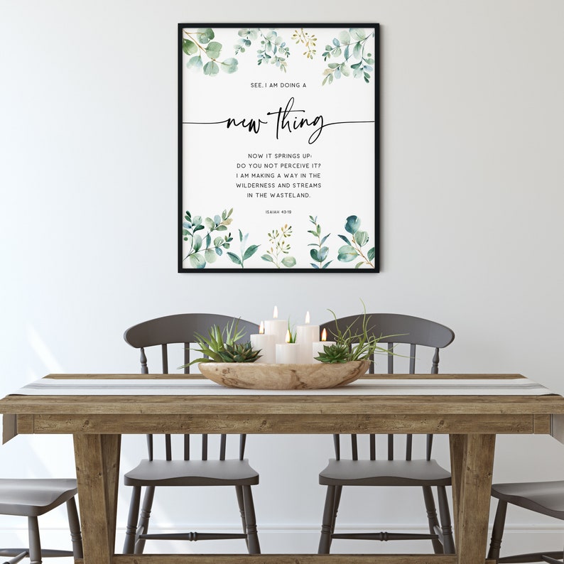 May include: A framed print with a watercolor design of green leaves and branches. The print features a quote from the Bible, Isaiah 43:19, "See, I am doing a new thing. Now it springs up; do you not perceive it? I am making a way in the wilderness and streams in the wasteland."