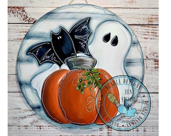 May include: A round wooden sign with a white background and blue accents. A pumpkin, a ghost, and a bat are painted on the sign. The sign has the text "Double Designs Jen Sketch" in a blue circle.