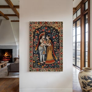 Vertical Krishna and Radha canvas wall art displayed on a white wall in a contemporary living room