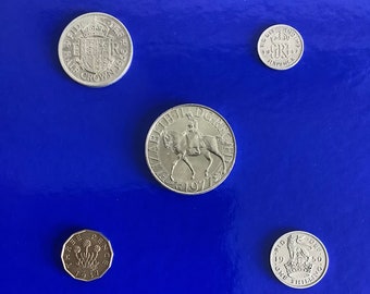 Set of collectible vintage British pre-decimal coins . One each of Commemorative Crown, Half Crown, Shilling, Sixpence and brass threepence