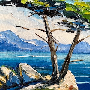 May include: Oil painting of a coastal landscape featuring a tree with green and black foliage, brown trunk, and branches. The background shows blue water, mountains, and a bright blue sky. The painting has a textured, impressionistic style.