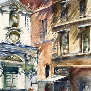Puede incluir: Pintura a la acuarela de una escena callejera europea con edificios en tonos beige, marrón y blanco. Se ve una pequeña tienda con la palabra "Yogurteria". La firma del artista "Kristina 2020" está en la esquina inferior izquierda.