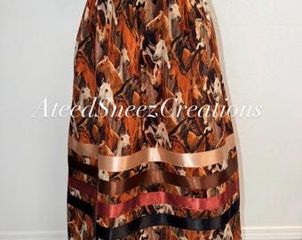 May include: A floor-length skirt featuring an all-over print of brown, white, and black horses. The hem is decorated with four horizontal satin ribbons in shades of beige, dark brown, rust, and black. The text AteedSheezCreations is overlaid.