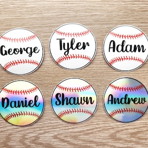May include: Six white baseball-themed stickers with red stitching and black text. The names "George", "Tyler", "Adam", "Daniel", "Shawn", and "Andrew" are printed on the stickers.