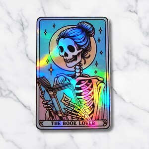The Book Lover Skeleton Holographic Sticker – Spooky Bookish Decal, Gothic Reader Vinyl, Multiple Sizes