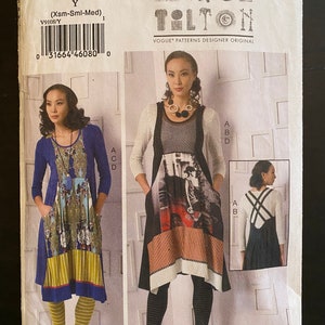 May include: A sewing pattern for a dress with two different styles. The first style is a blue dress with a floral print and a yellow stripe. The second style is a black dress with a colorful print and a red stripe. The pattern is from Vogue Patterns Designer Original and is called March Tolton.