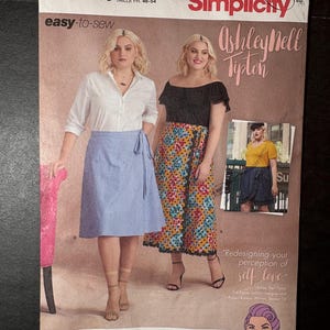 May include: Simplicity sewing pattern featuring Ashley Nell Tipton designs. The pattern includes images of women wearing skirts and tops. The pattern is for sizes 18W-26W and is easy-to-sew.