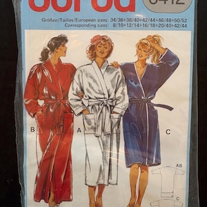 May include: A Burda 6412 sewing pattern package featuring illustrations of three bathrobes in red, white, and blue. The package includes size information in European and corresponding US sizes. The Burda logo is at the top.