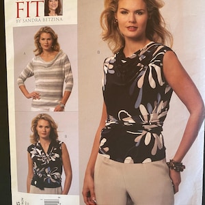 May include: A sewing pattern for two tops. The first top is a striped, long-sleeved top with a cowl neck. The second top is a sleeveless top with a floral print and a wrap detail. The pattern is from Vogue Patterns and is called "Today's Fit" by Sandra Betzina.
