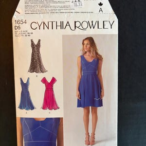 May include: A Simplicity sewing pattern for a dress, pattern number 1654, designed by Cynthia Rowley. The pattern includes three different dress styles: a sleeveless dress with a scoop neck, a sleeveless dress with a V-neck, and a dress with short sleeves and a V-neck. The pattern is for sizes US 4-12, Euro 30-38, and French 32-40.