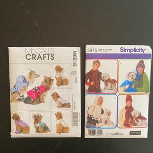 Pode incluir: Dois padrões de costura para fazer roupas para cães. O padrão à esquerda é McCall's Crafts M6218 e apresenta uma variedade de suéteres e casacos para cães. O padrão à direita é Simplicity 3975 e apresenta um conjunto de suéter e cachecol para cães.
