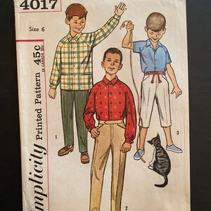 May include: Simplicity Printed Pattern 4017, size 6, for making boys' clothing. The pattern includes three illustrations of boys wearing different outfits. The first boy is wearing a plaid shirt and pants. The second boy is wearing a red and white patterned shirt and tan pants. The third boy is wearing a blue shirt and white pants.